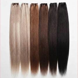 Beauté La Muse seamless clip-in human hair extensions in a gradient of blonde to black shades on a white background.